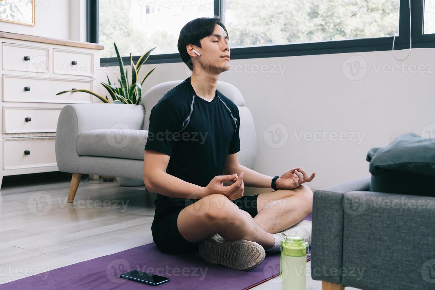 Young Asian man exercising at home photo
