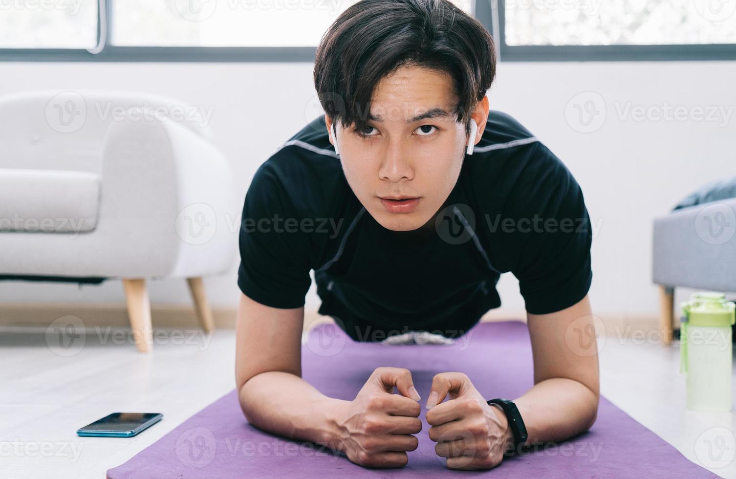 Young Asian man exercising at home photo