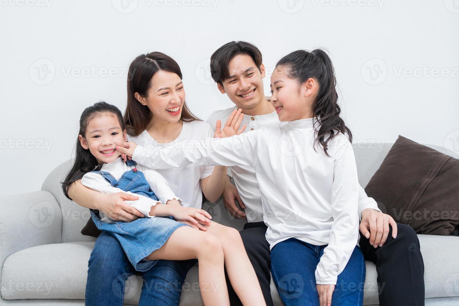 Young Asian family entertained at home in free time photo