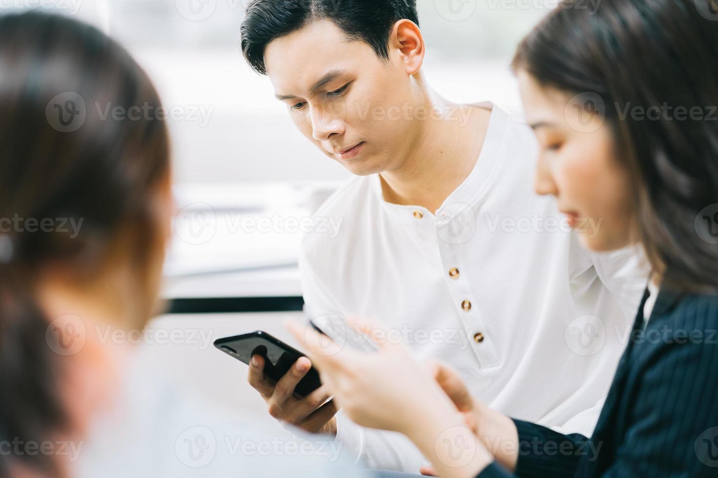 Young Asians are using their phones to connect with each other through social networking platforms photo