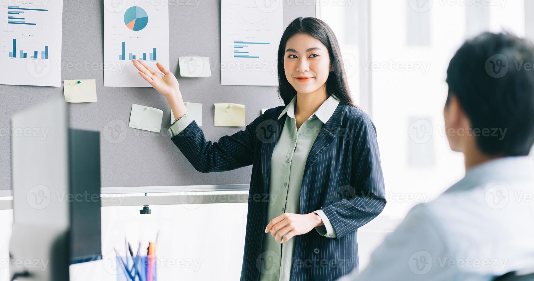 The young female director is working out a plan for the staff to implement photo