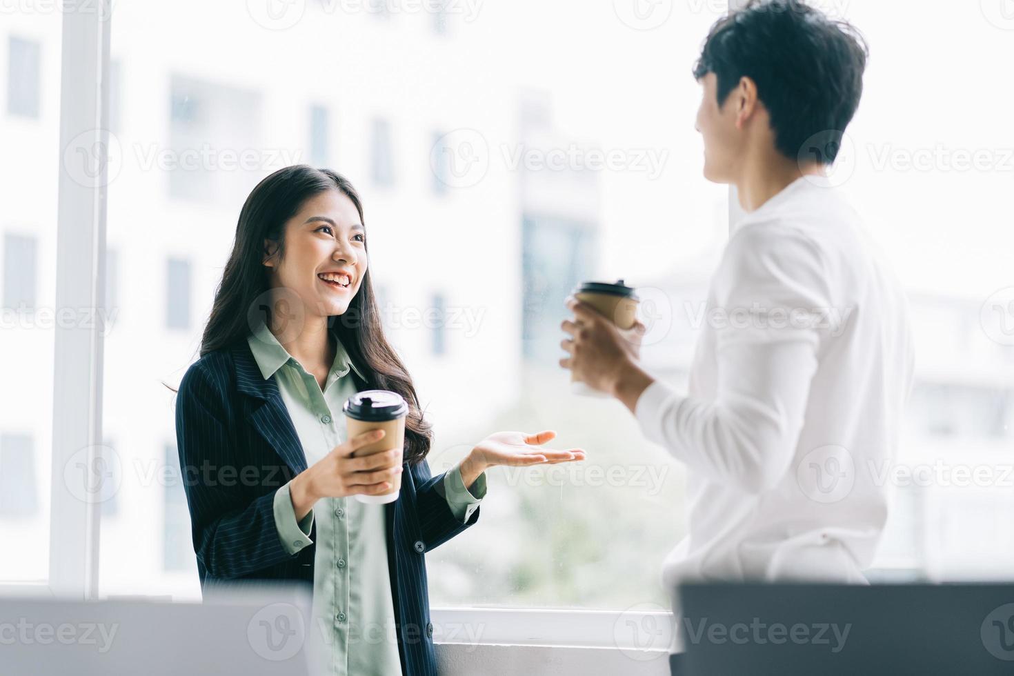 Businessman and businesswoman are discussing each other during lunch break photo