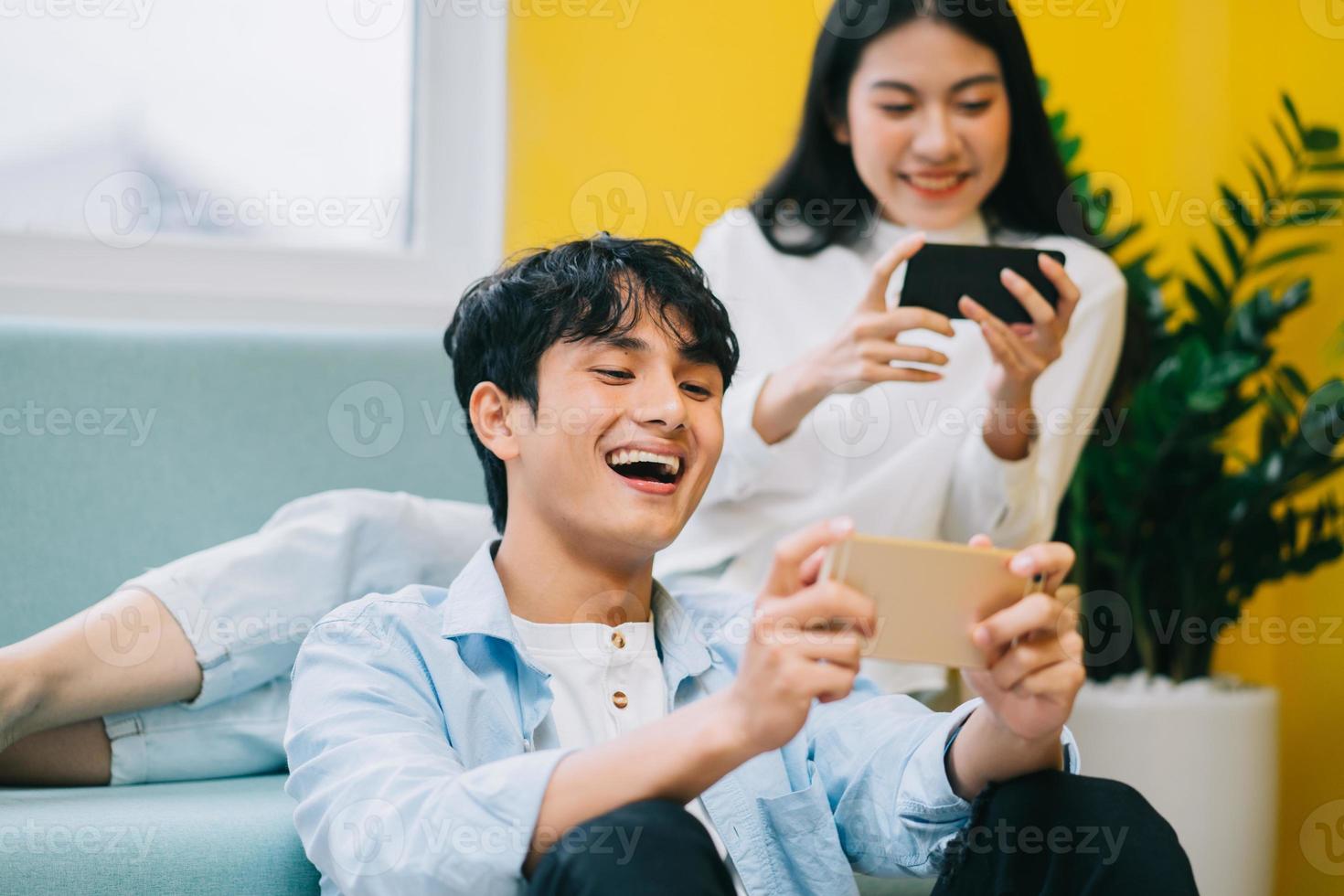 Asian couple playing games at home together, the happy life of a newlyweds photo