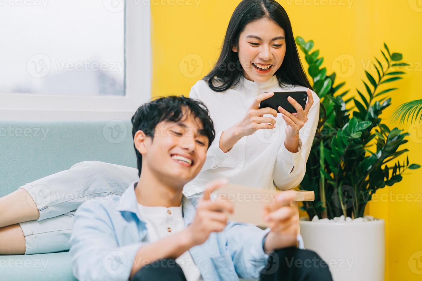Asian couple playing games at home together, the happy life of a newlyweds photo