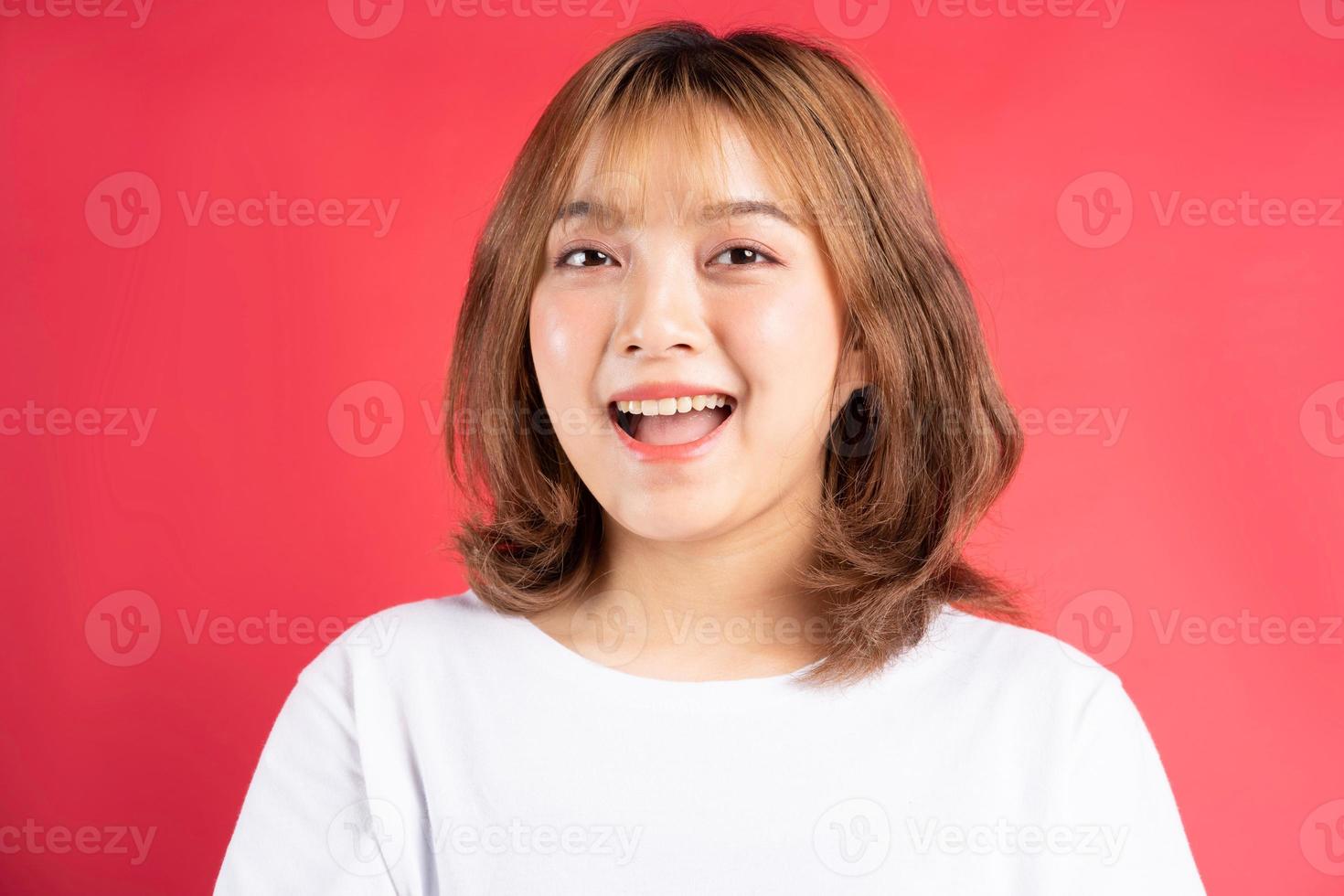 Young Asian girl with cheerful gestures and expressions on background ...