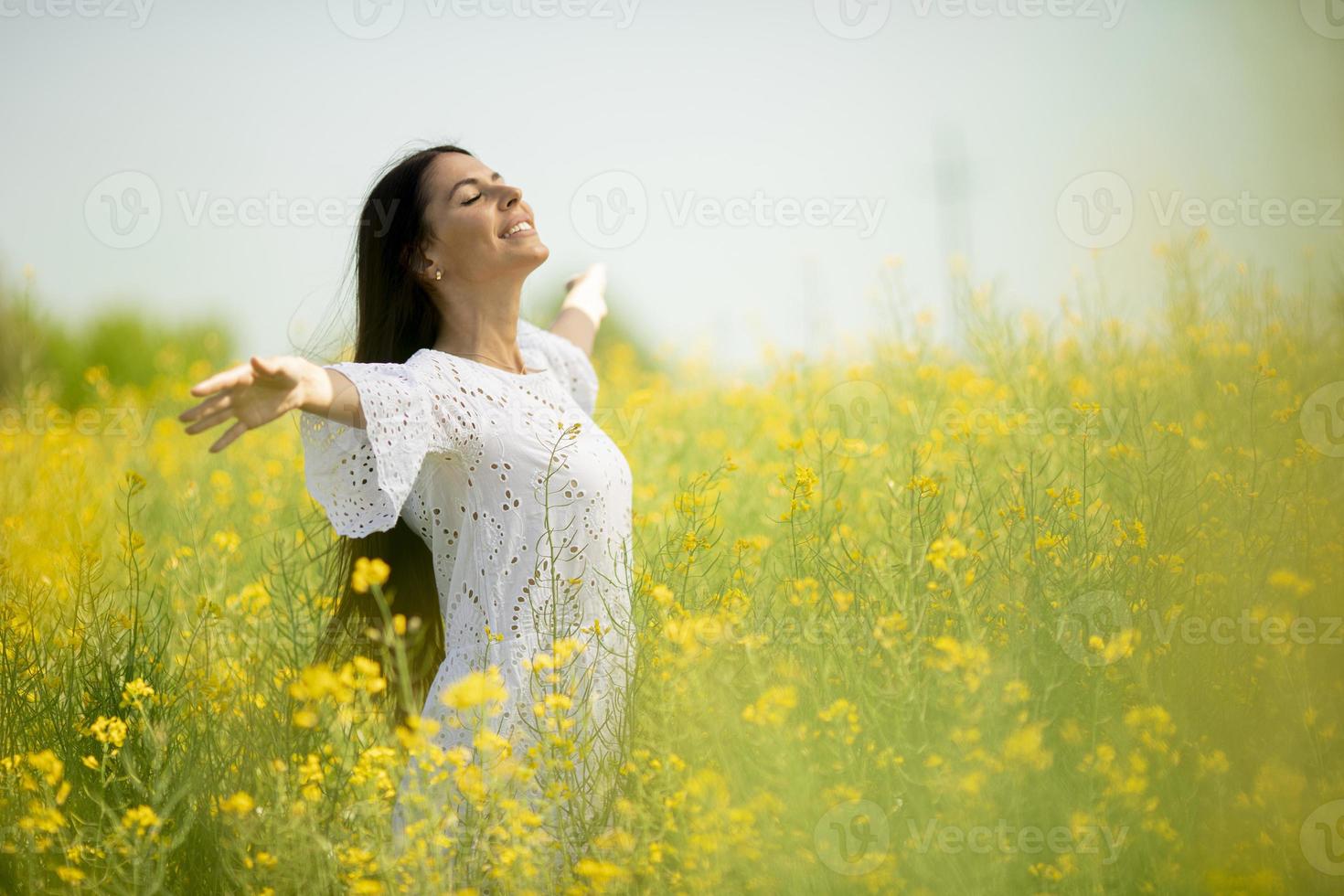 Young woman in the rapeseed field photo