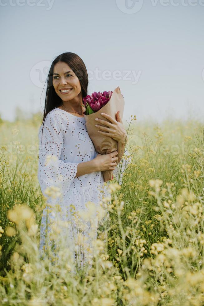 Young woman in the rapeseed field photo