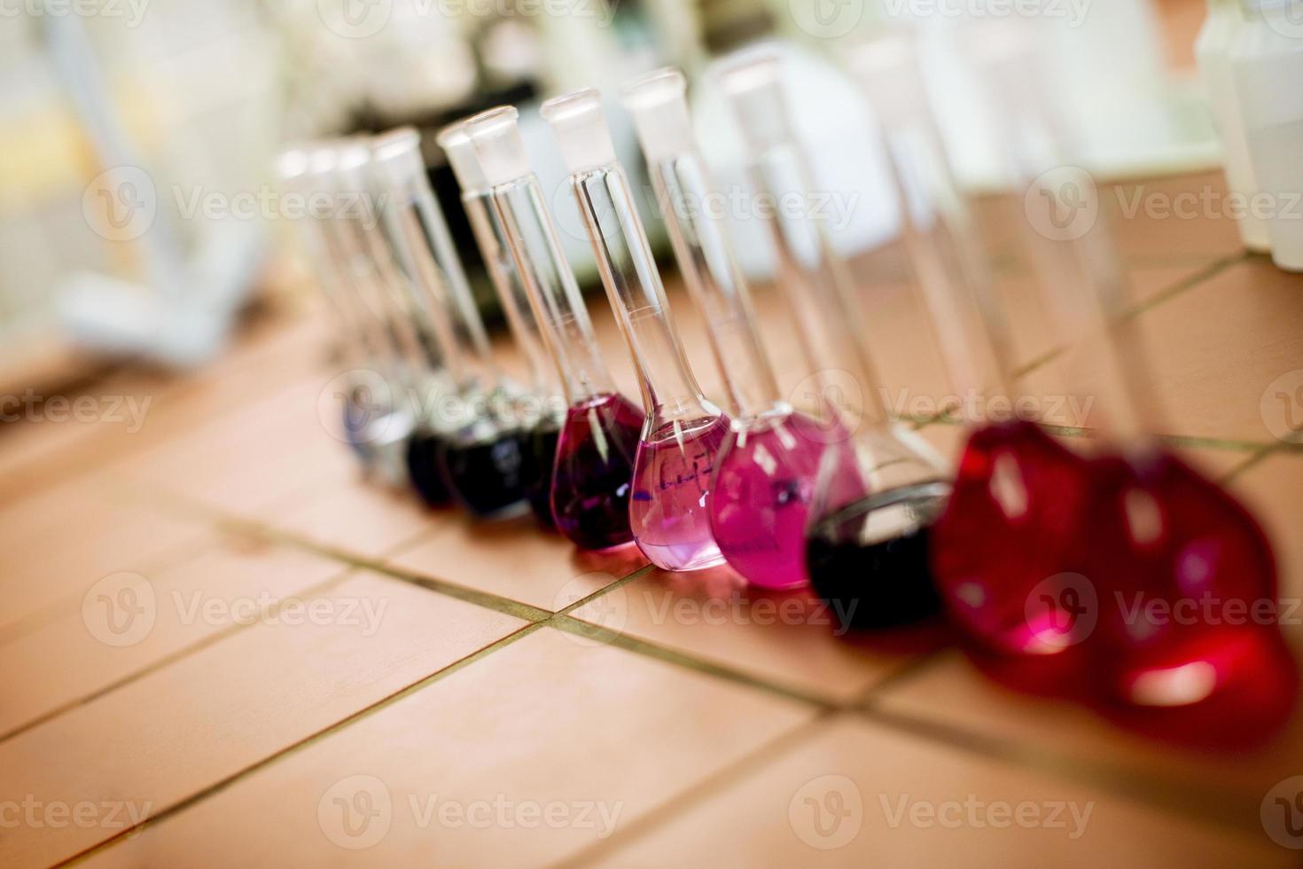 Row of flasks with liquids in the lab photo
