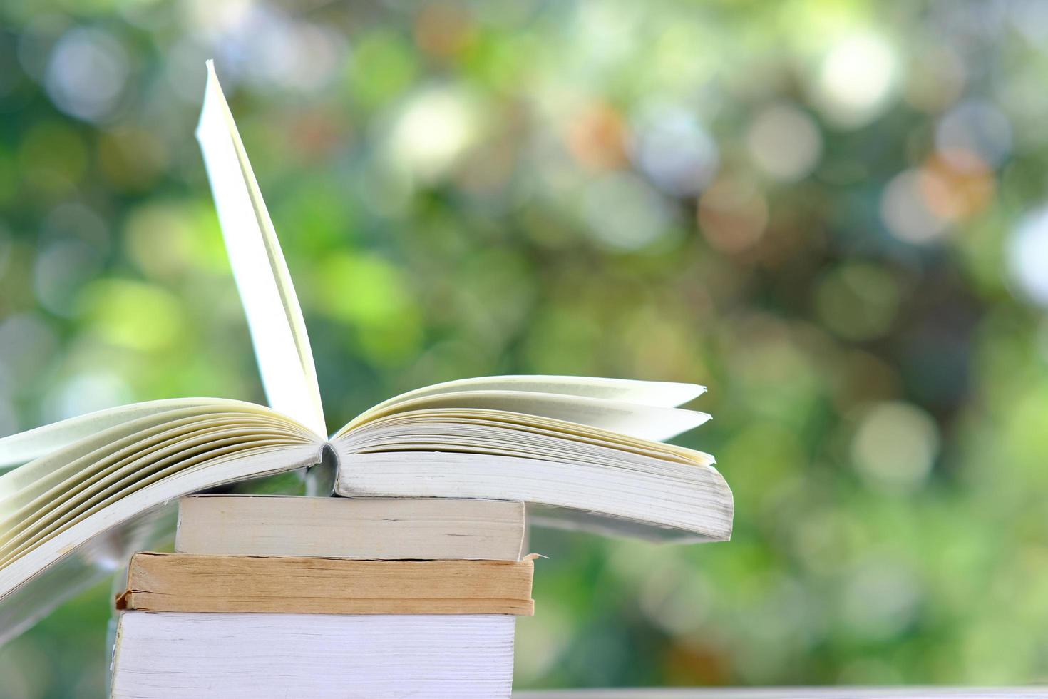 Libro sobre la mesa de madera y el aprendizaje educativo en la biblioteca, apilar montones de libros sobre la mesa y el concepto de idea foto