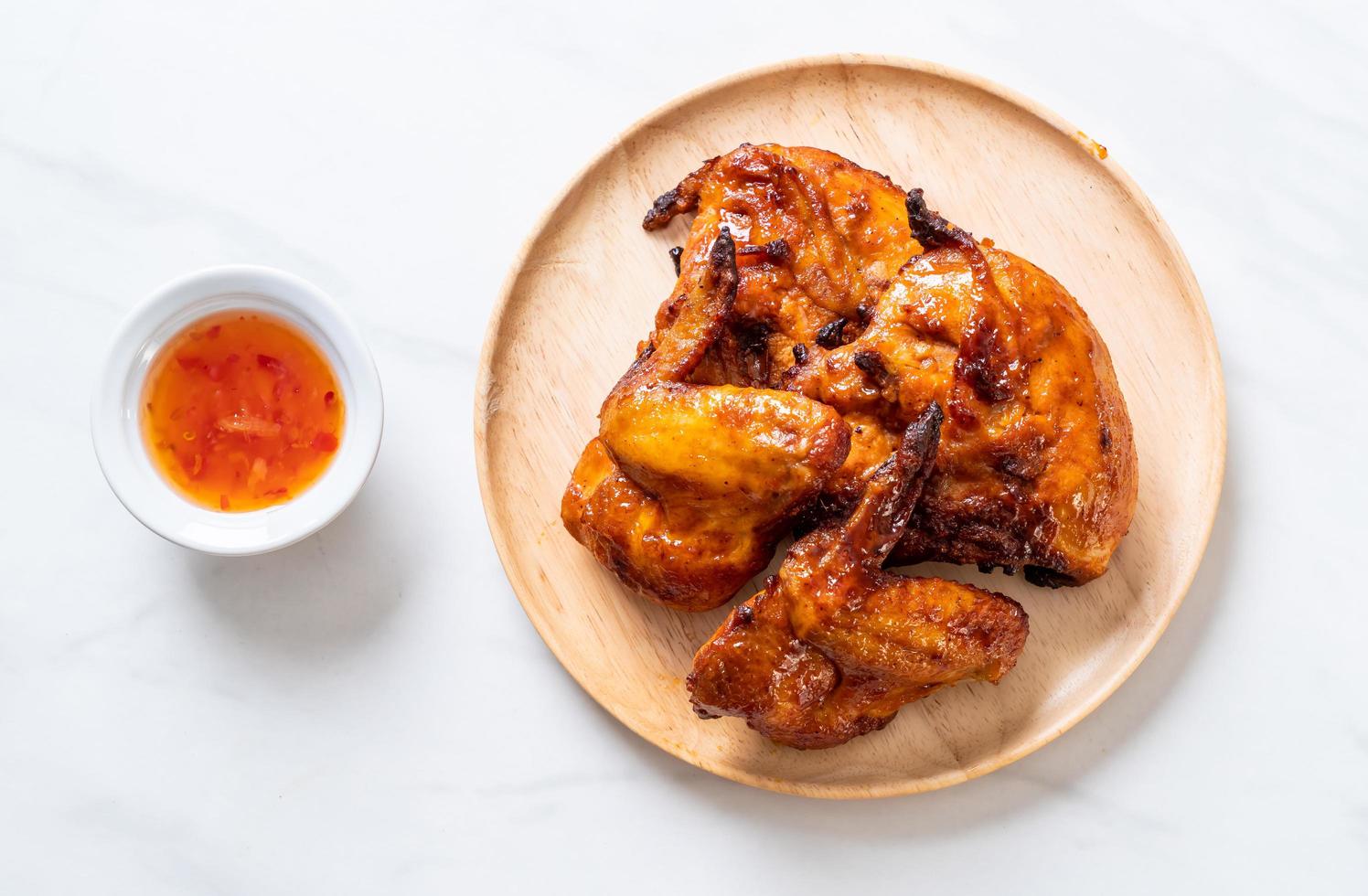 Grilled and barbecue chicken on a table photo