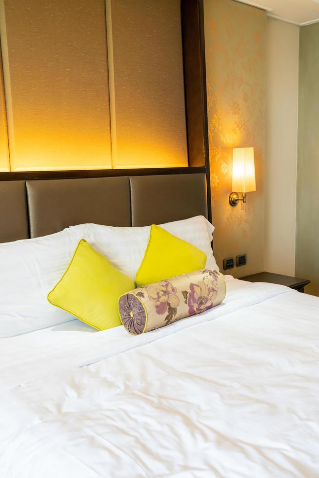 Comfortable pillow decoration on bed in hotel bedroom photo