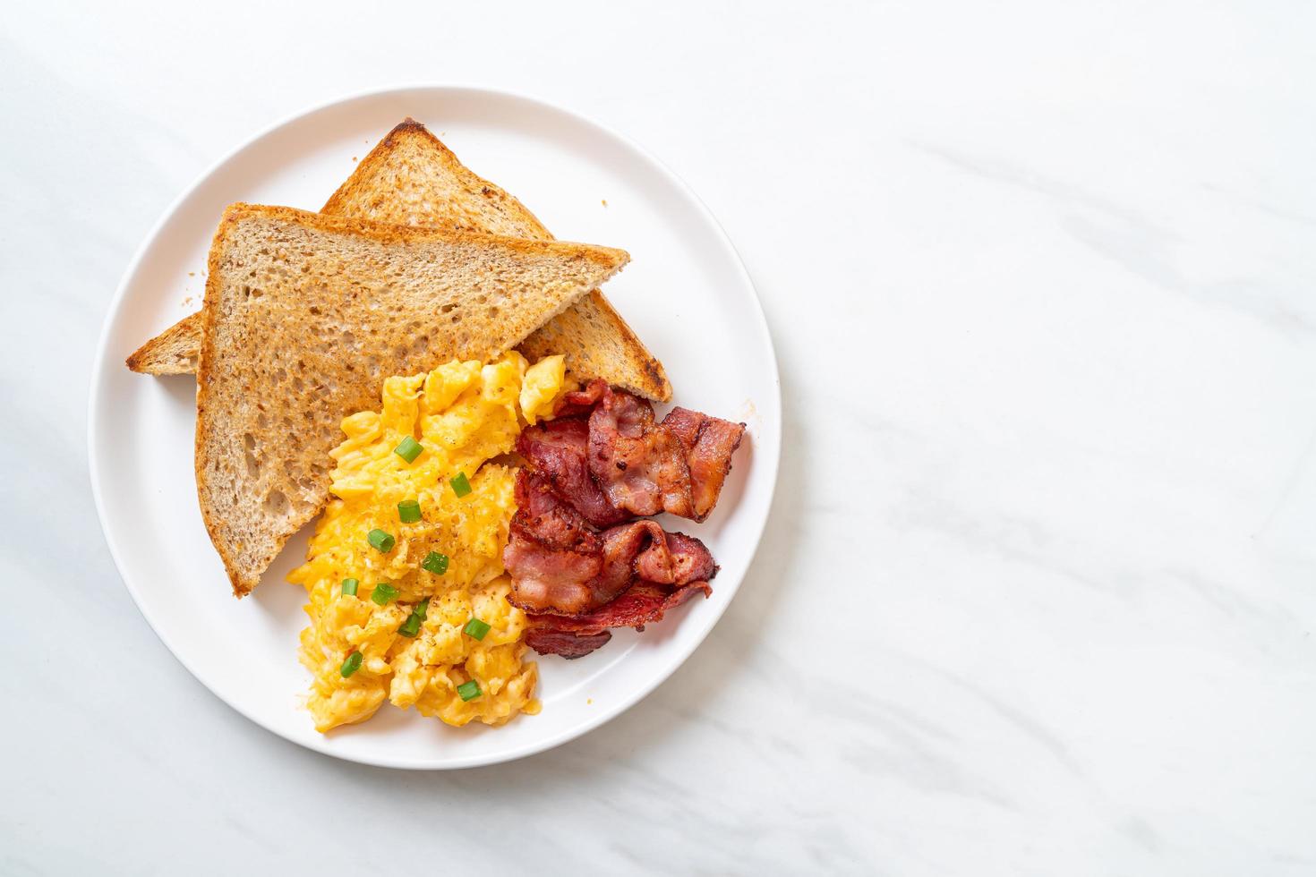 Scrambled egg with bread toasted and bacon for breakfast photo