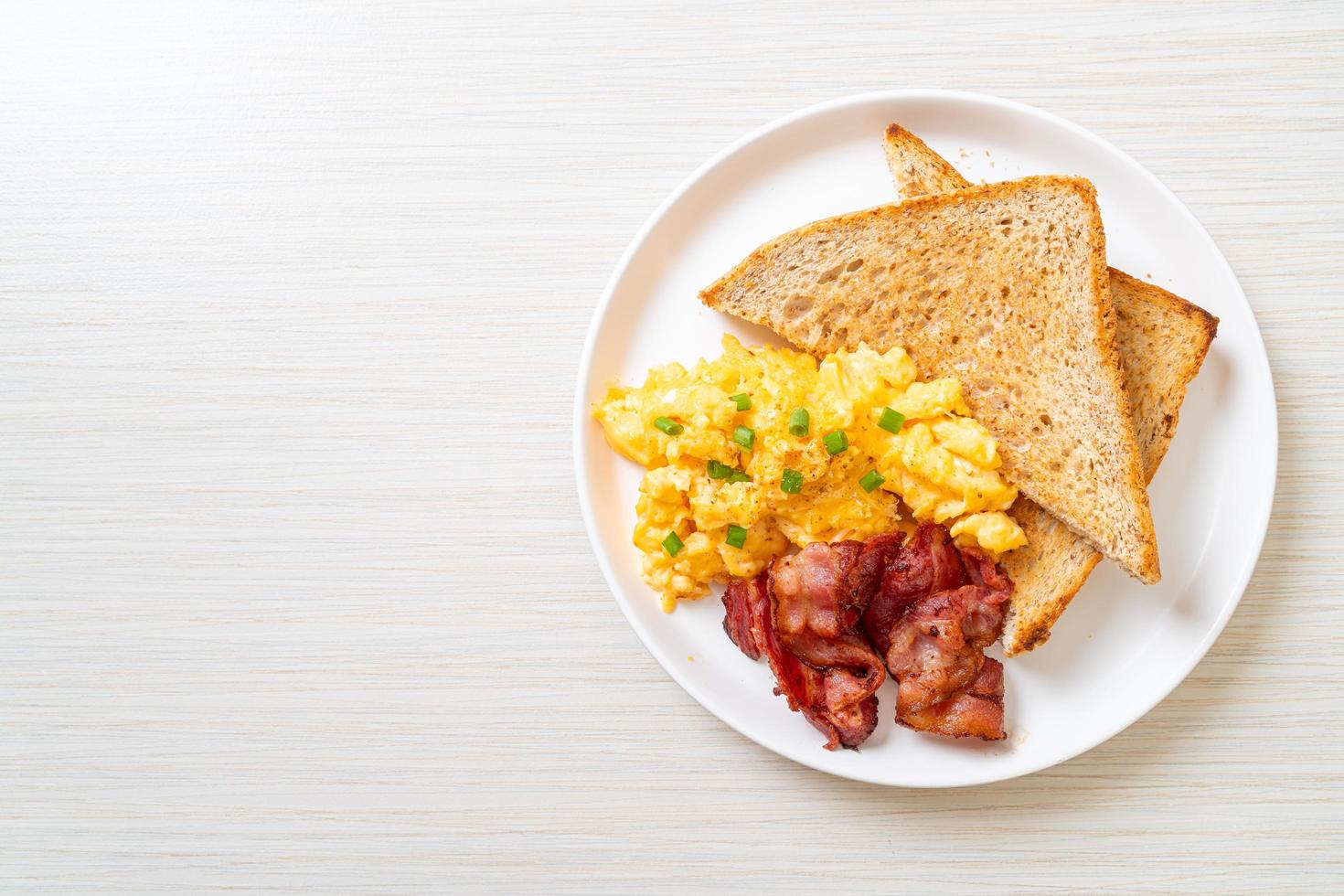 huevos revueltos con pan tostado y tocino para el desayuno foto