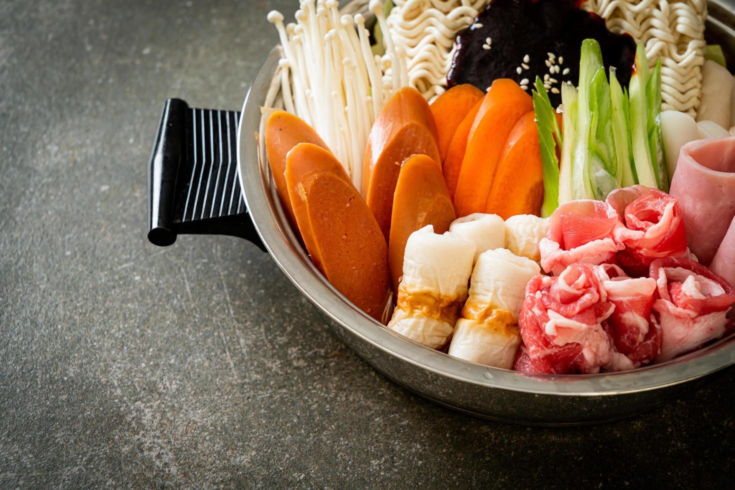 Budae Jjigae or Budaejjigae, Army stew or Army base stew. It is loaded with Kimchi, spam, sausages, ramen noodles and much more - popular Korean hot pot food style photo