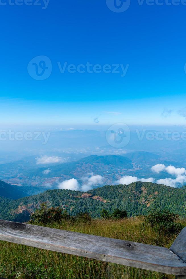 Beautiful mountain layer with clouds and blue sky at Kew Mae Pan Nature Trail in Chiang Mai, Thailand photo