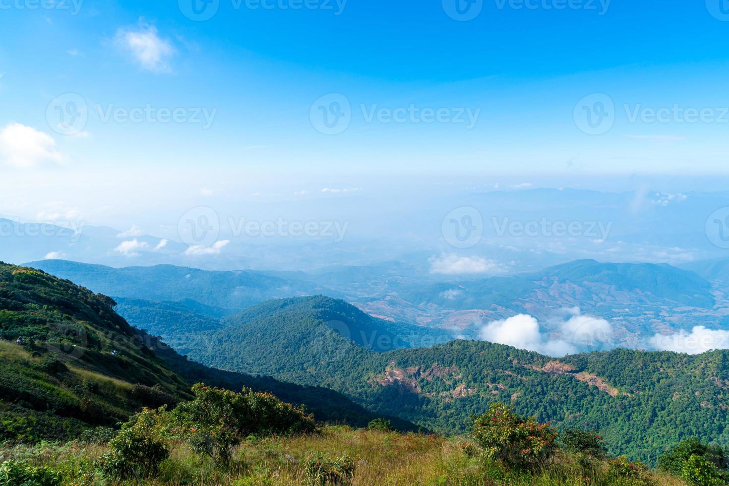 Beautiful mountain layer with clouds and blue sky at Kew Mae Pan Nature Trail in Chiang Mai, Thailand photo