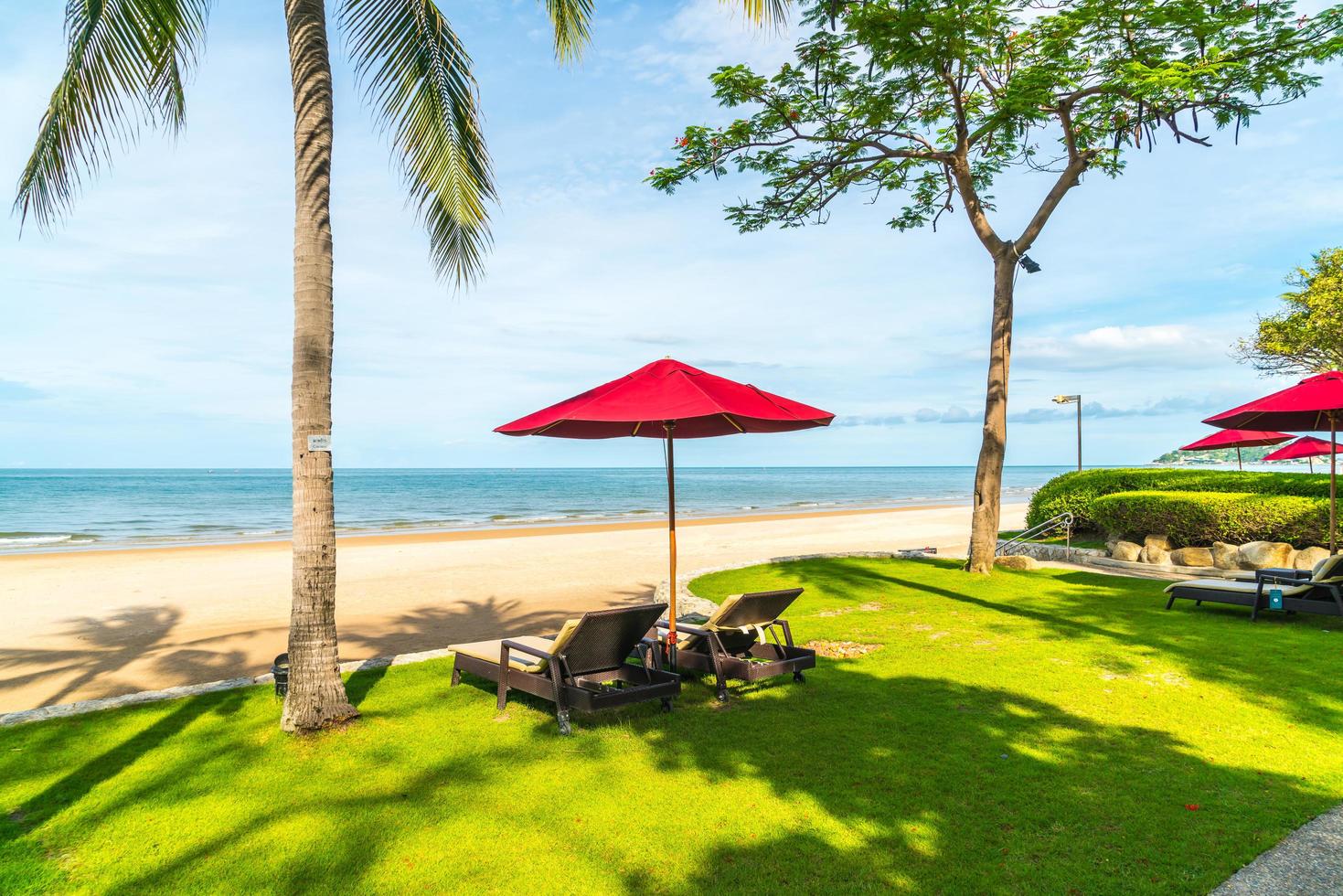 Umbrella and chairs with sea ocean view in hotel resort for holiday vacation travel concept photo