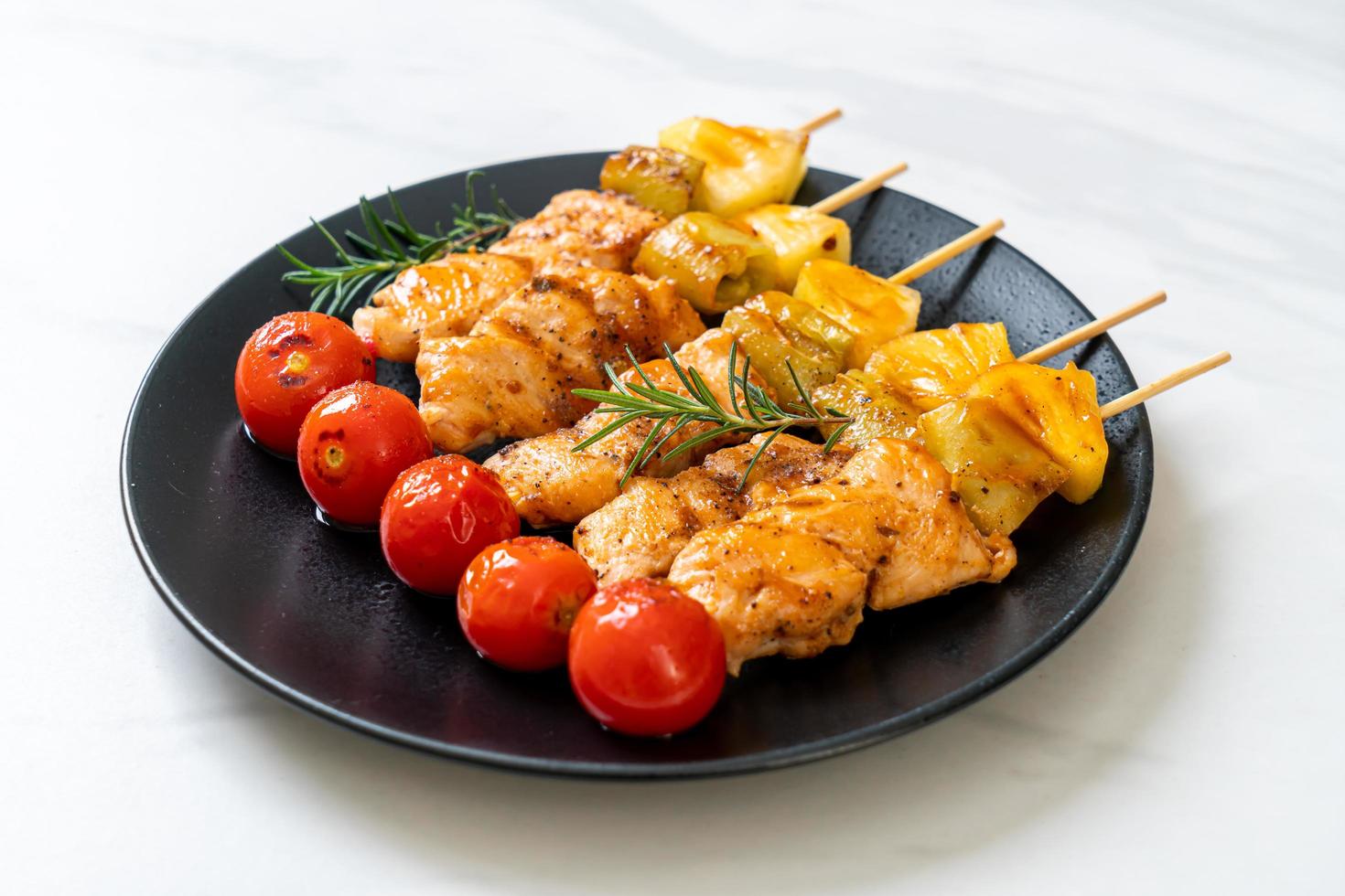 Grilled chicken barbecue skewer on plate photo