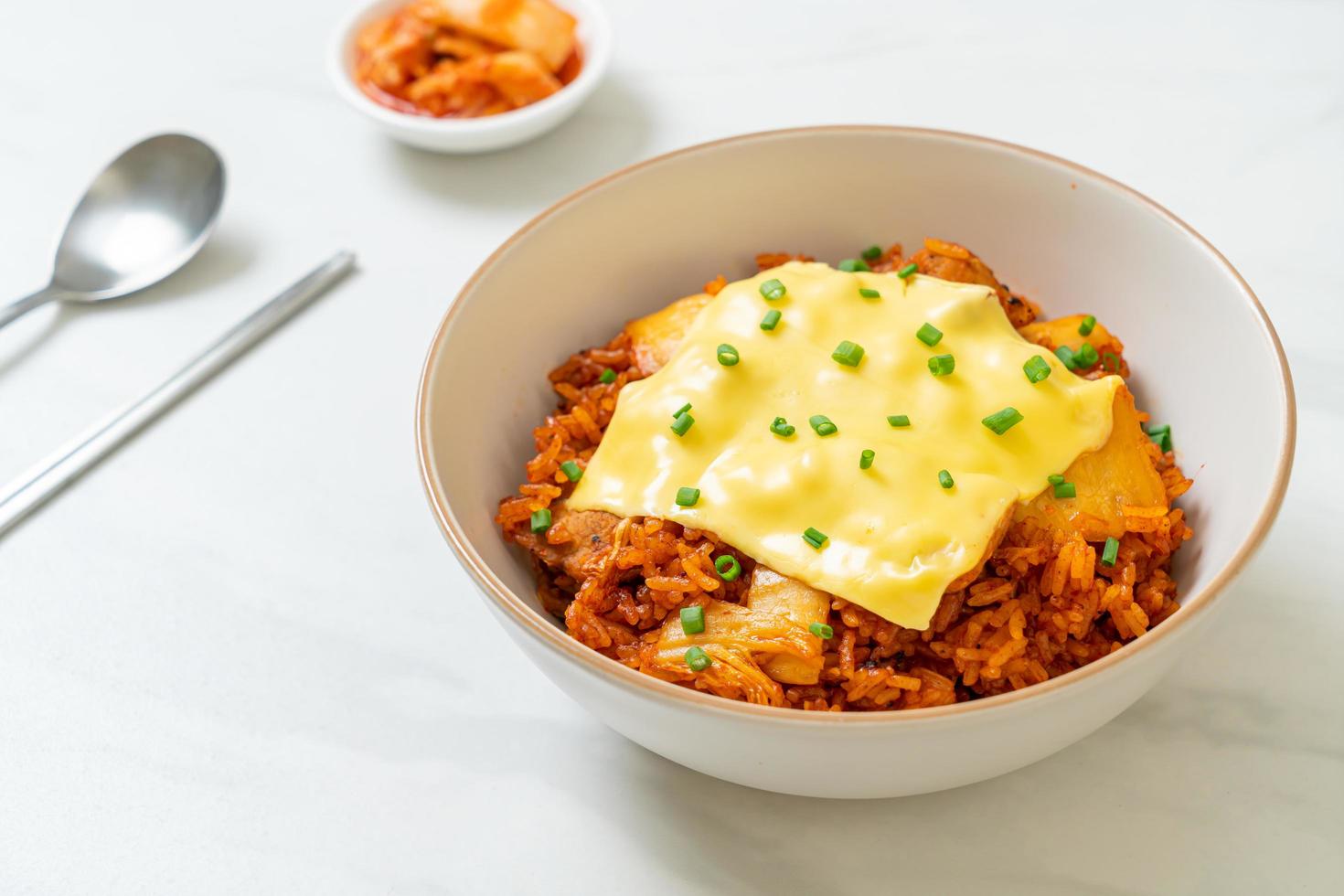 Kimchi fried rice with pork and topped cheese - Asian and fusion food style photo