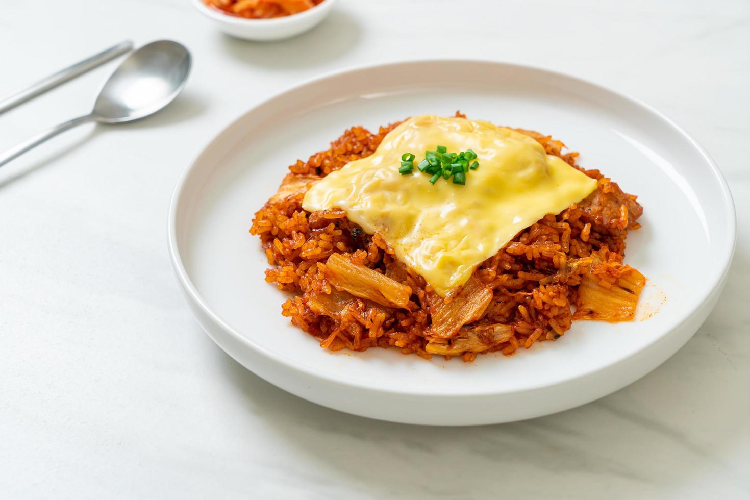 Kimchi fried rice with pork and topped cheese - Asian and fusion food style photo