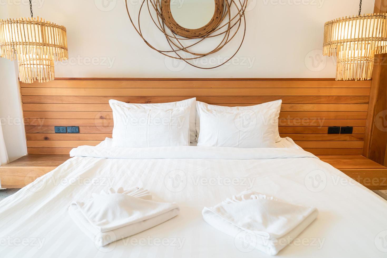 White pillow decoration on bed in bedroom interior photo