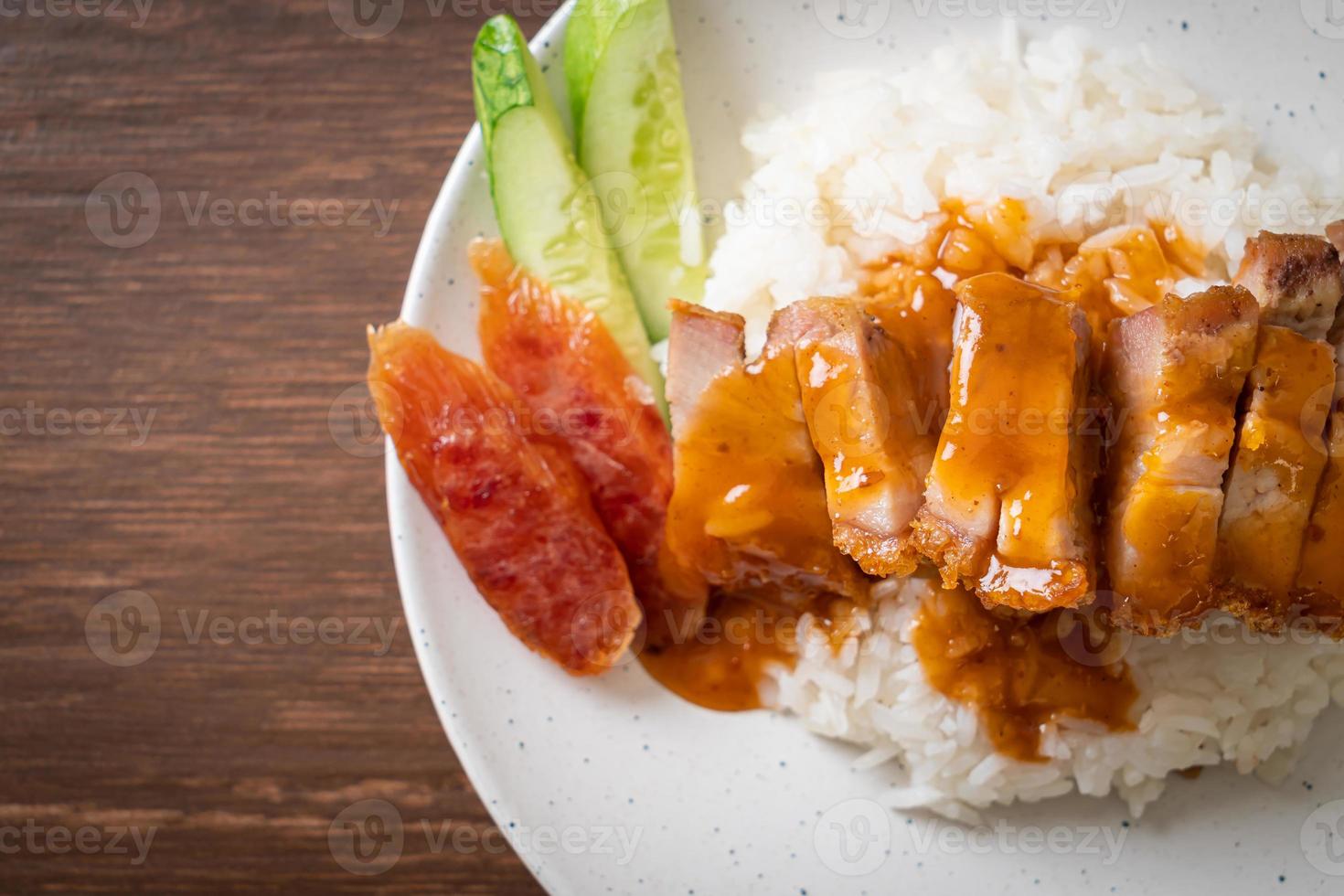 Crispy belly pork on rice with barbecue red sauce photo