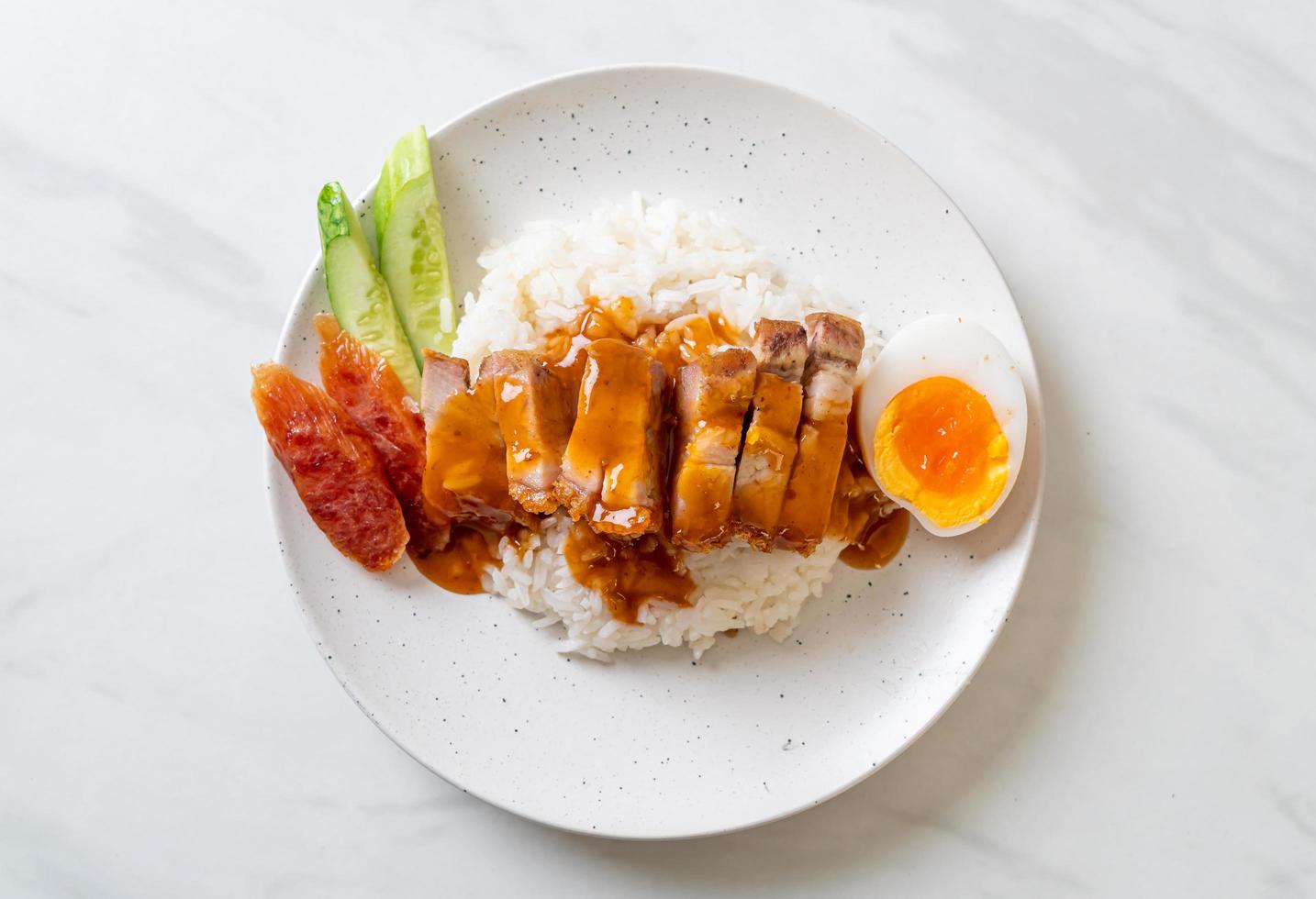 Crispy belly pork on rice with barbecue red sauce photo