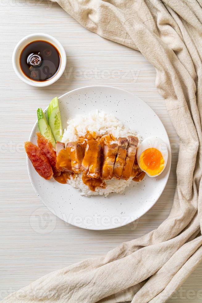 Crispy belly pork on rice with barbecue red sauce photo