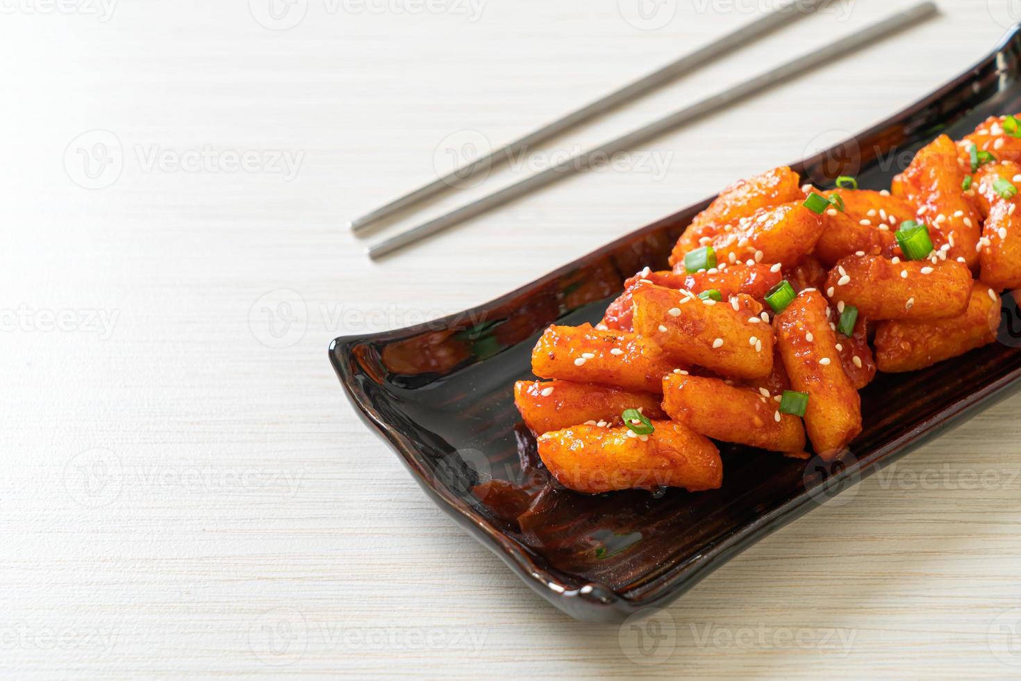 Deep-fried Korean rice cake, or Tteokbokki, skewered with spicy sauce - Korean food style photo