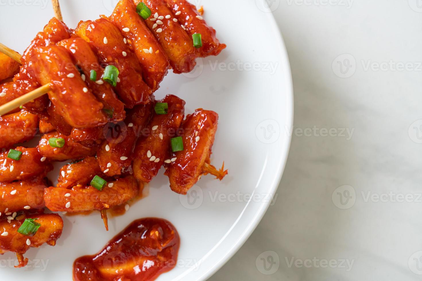 Deep-fried Korean rice cake, or Tteokbokki, skewered with spicy sauce - Korean food style photo