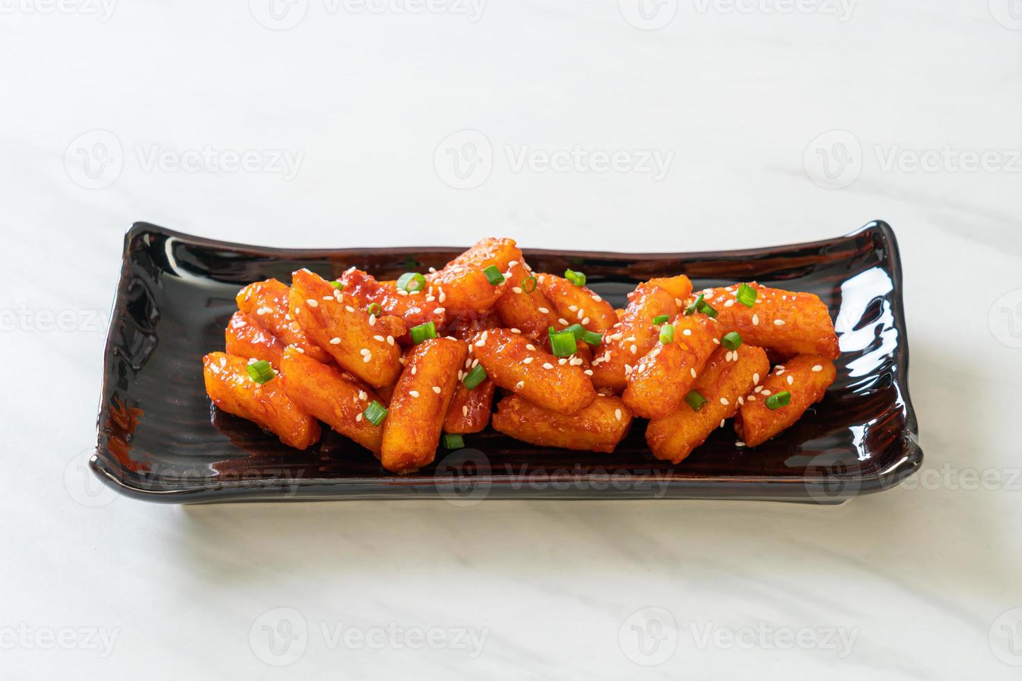 Deep-fried Korean rice cake, or Tteokbokki, skewered with spicy sauce - Korean food style photo