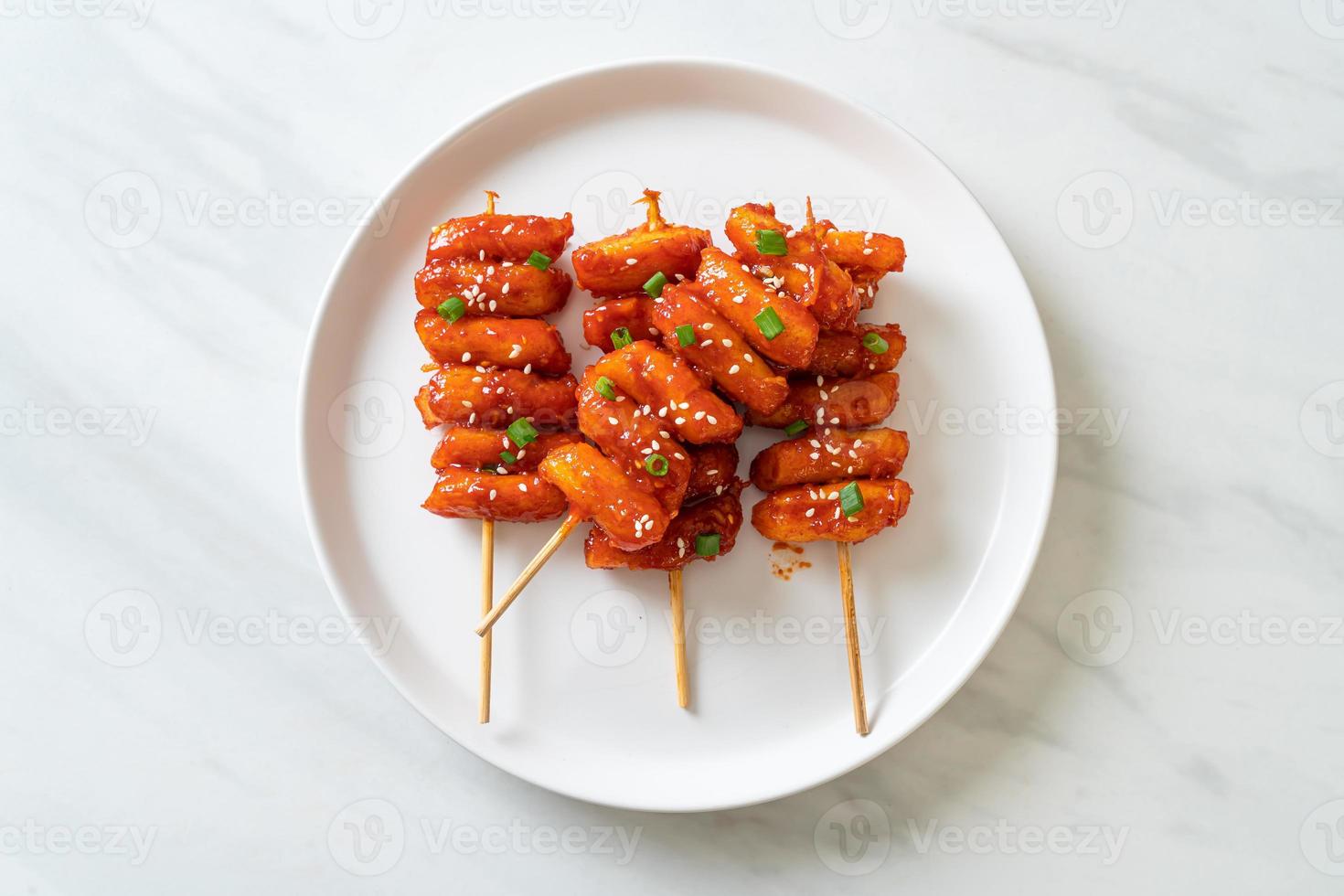 Deep-fried Korean rice cake, or Tteokbokki, skewered with spicy sauce - Korean food style photo