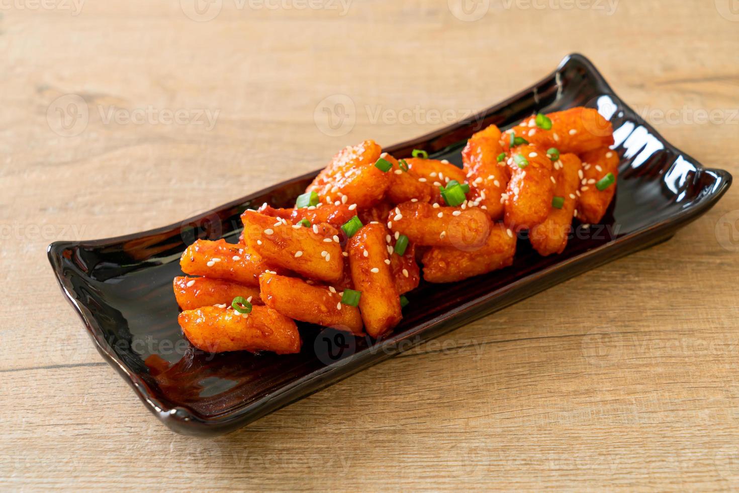 Deep-fried Korean rice cake, or Tteokbokki, skewered with spicy sauce - Korean food style photo