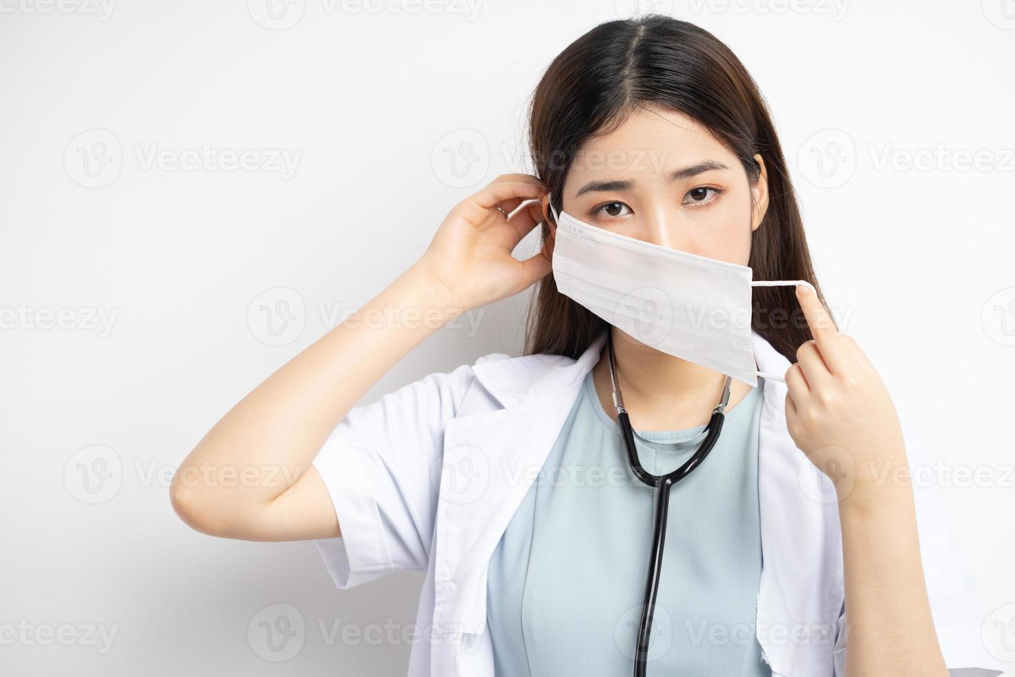 Female doctor instructing to wear a mask properly photo