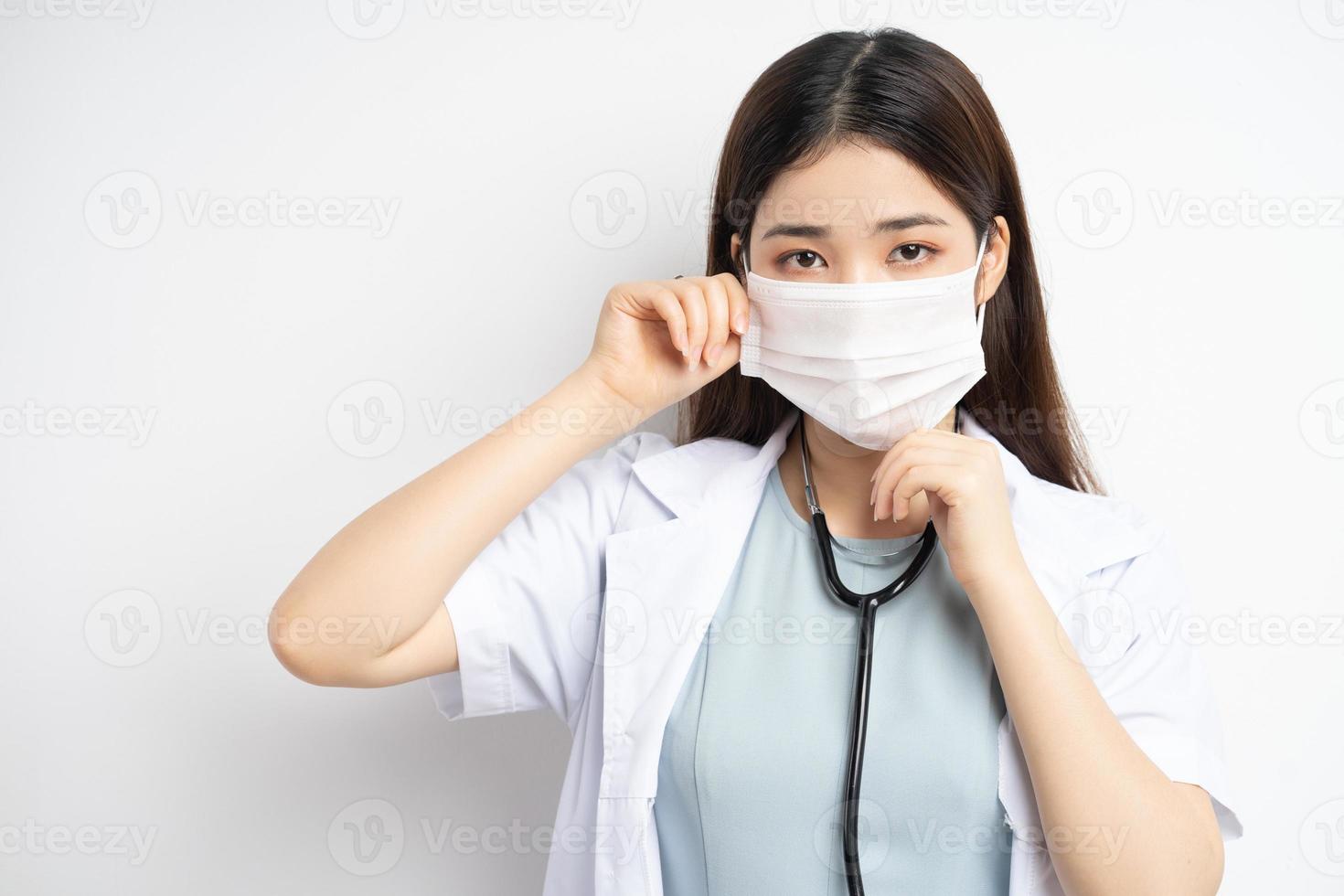 Female doctor instructing to wear a mask properly photo