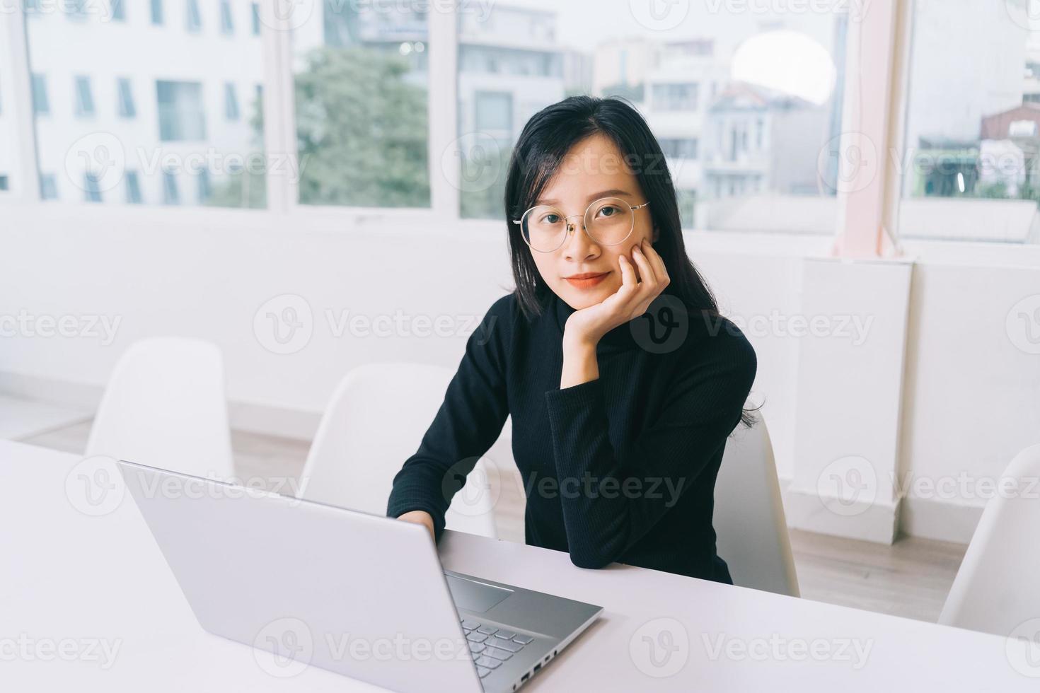 Young Asian woman using laptop in the office photo