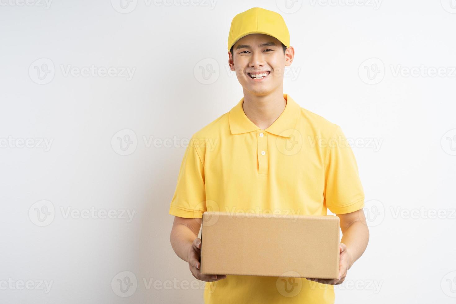 Asian courier holding parcel on white background photo