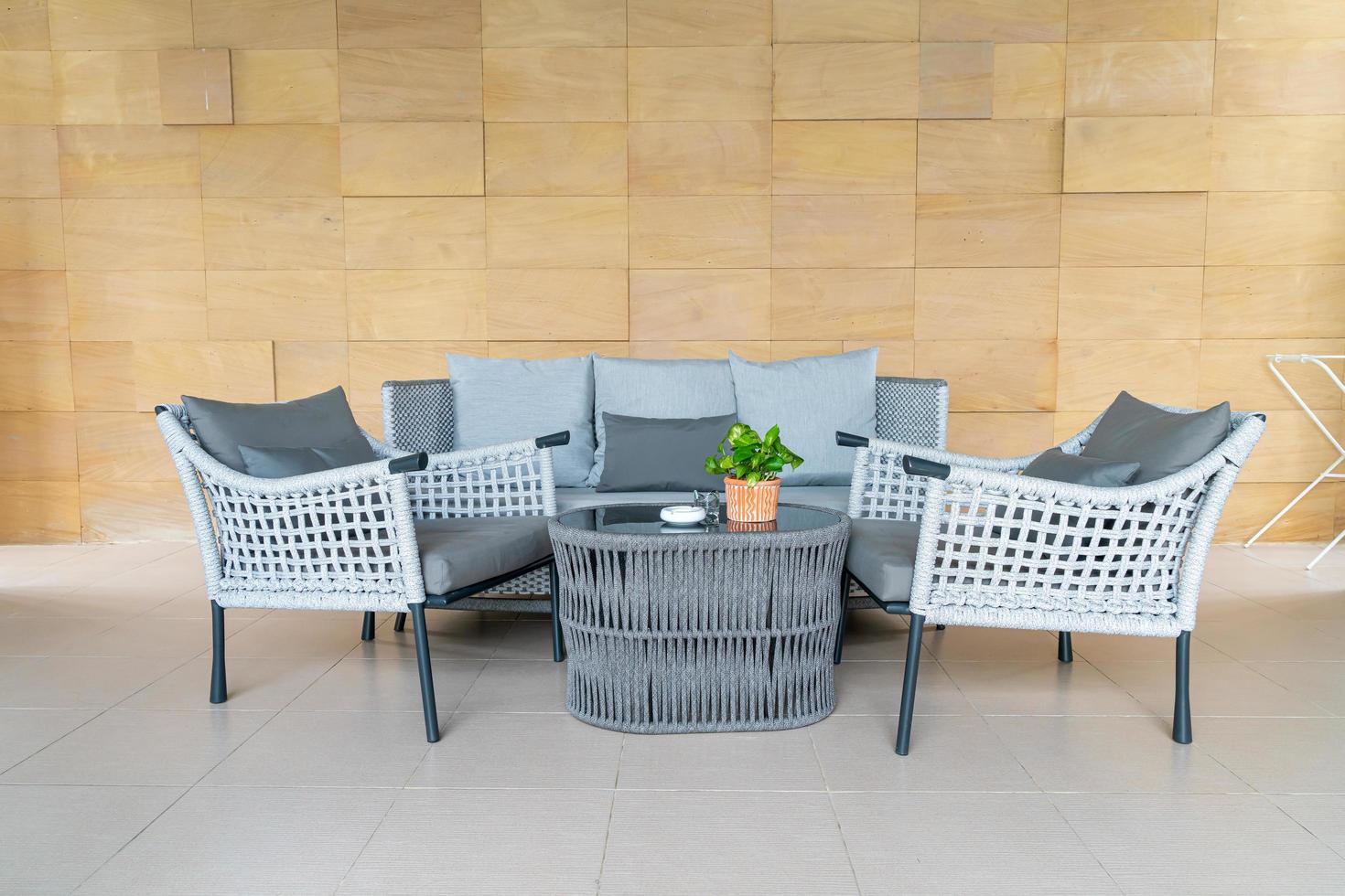 Empty outdoor patio chair and table with pillow photo