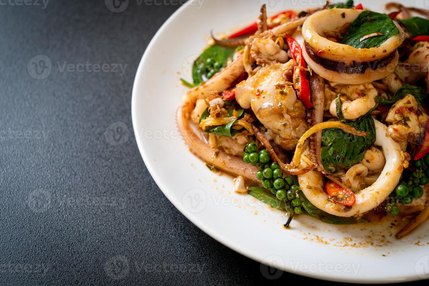 Stir-fried holy basil with octopus or squid and herb - Asian food style photo