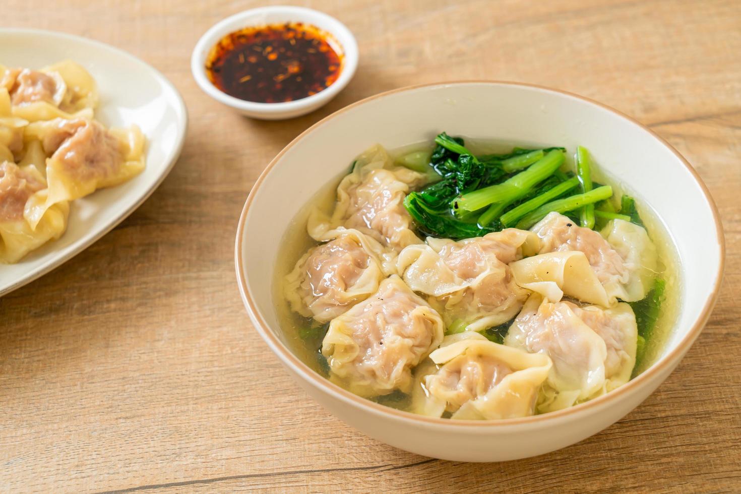Pork wonton soup or pork dumpling soup with vegetables - Asian food style photo