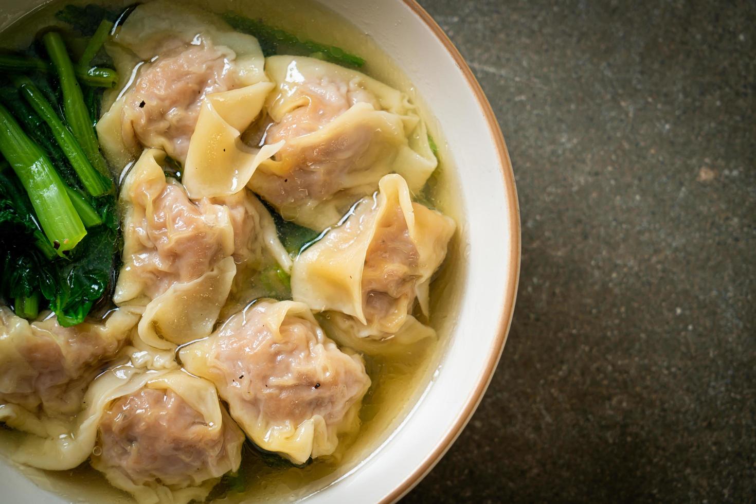 Pork wonton soup or pork dumpling soup with vegetables - Asian food style photo