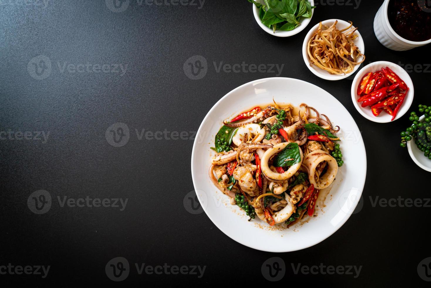 Stir-fried holy basil with octopus or squid and herb - Asian food style photo