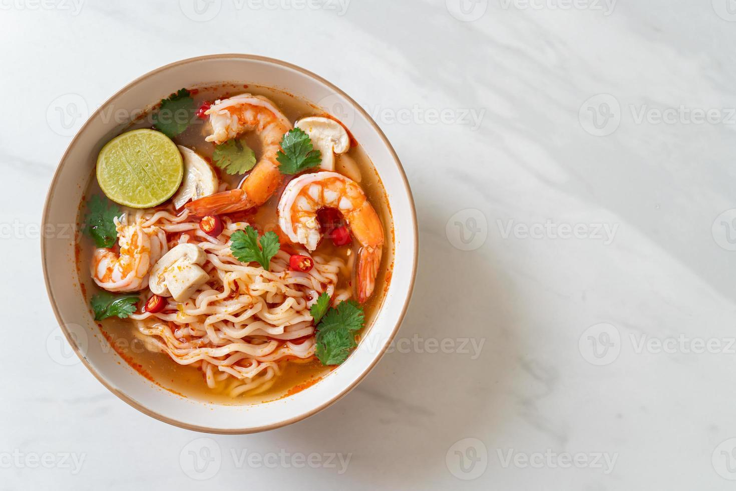 fideos instantáneos ramen en sopa picante con camarones, o tom yum kung - estilo de comida asiática foto
