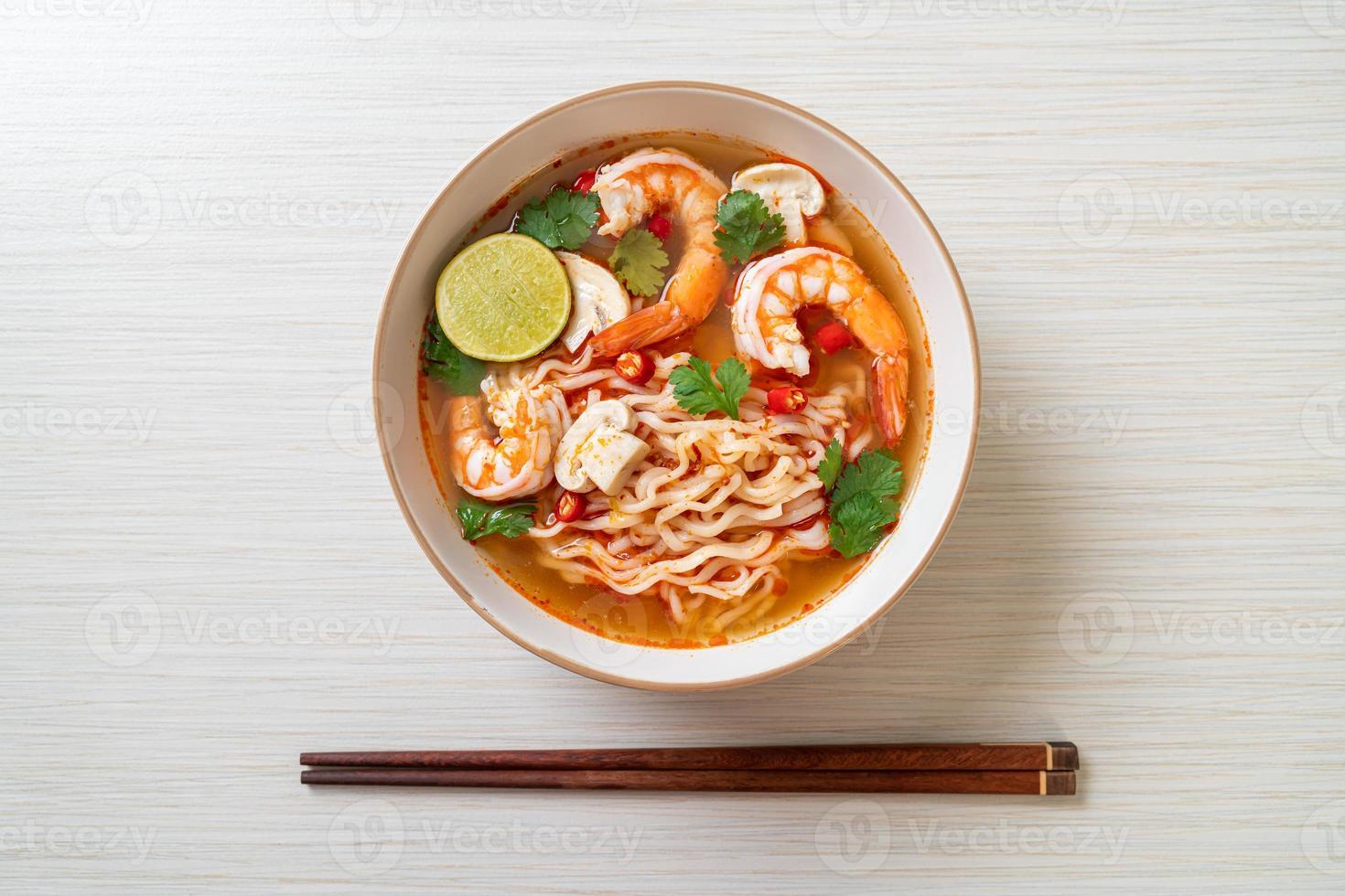 Instant noodles ramen in spicy soup with shrimps, or Tom Yum Kung - Asian food style photo