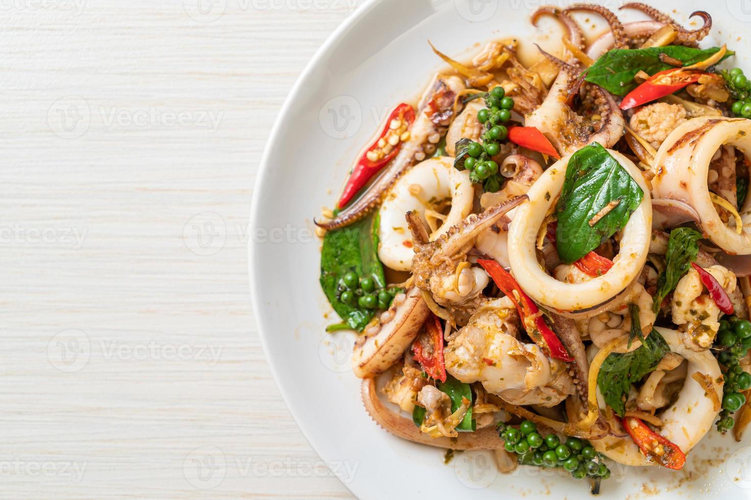 Stir-fried holy basil with octopus or squid and herb - Asian food style photo