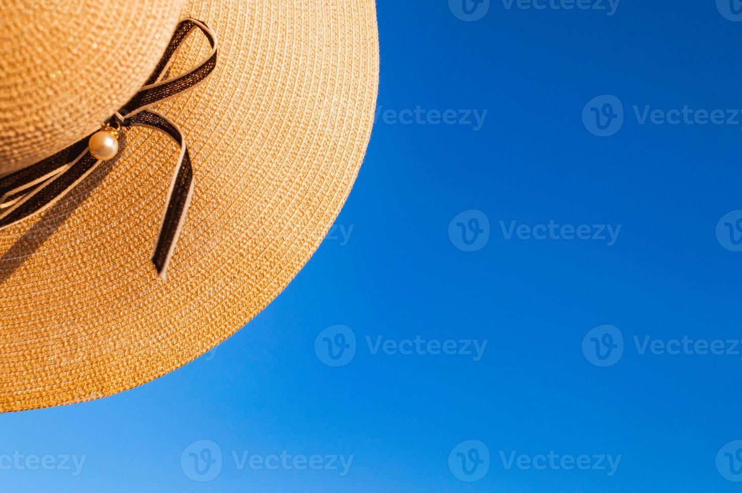 Part of summer hat on background of clear blue sky photo