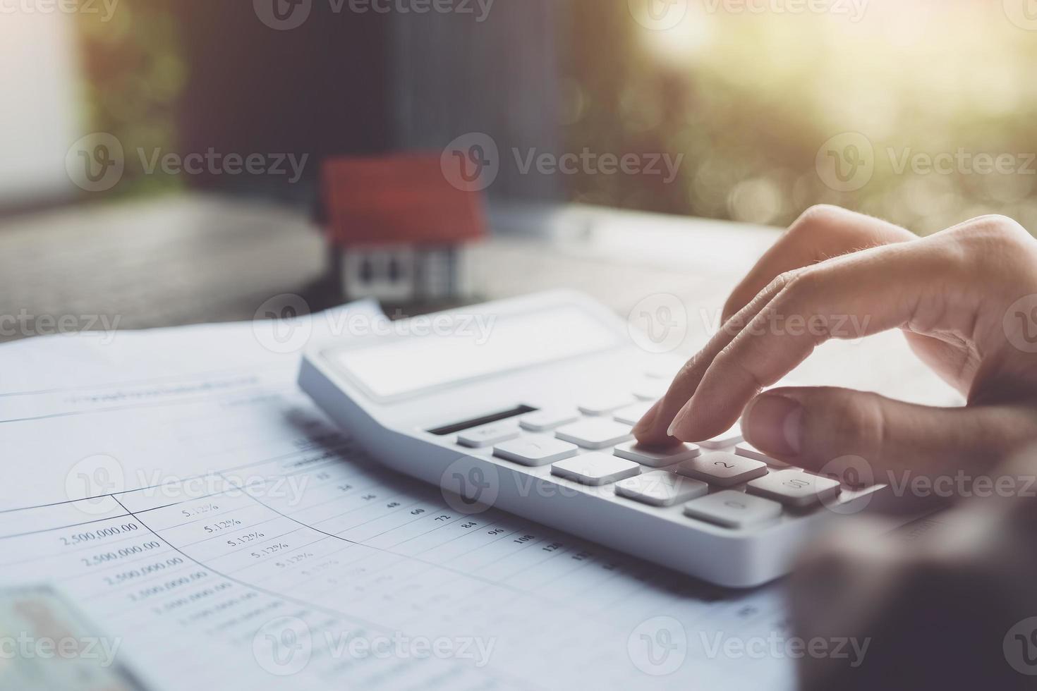 Customers use pens and calculators to calculate home purchase loans according to loan documents received from the bank. real estate concept. photo