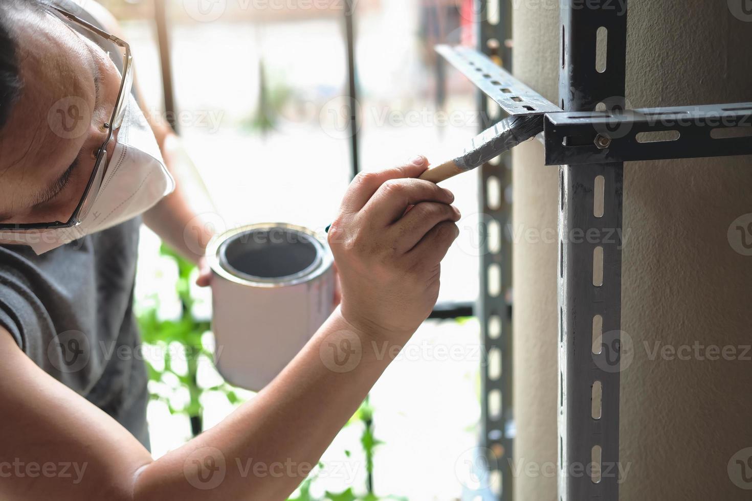 do it yourself concept, Craftsmen use anti-rust paint to paint old iron parts. Make a shelf on your free weekend photo