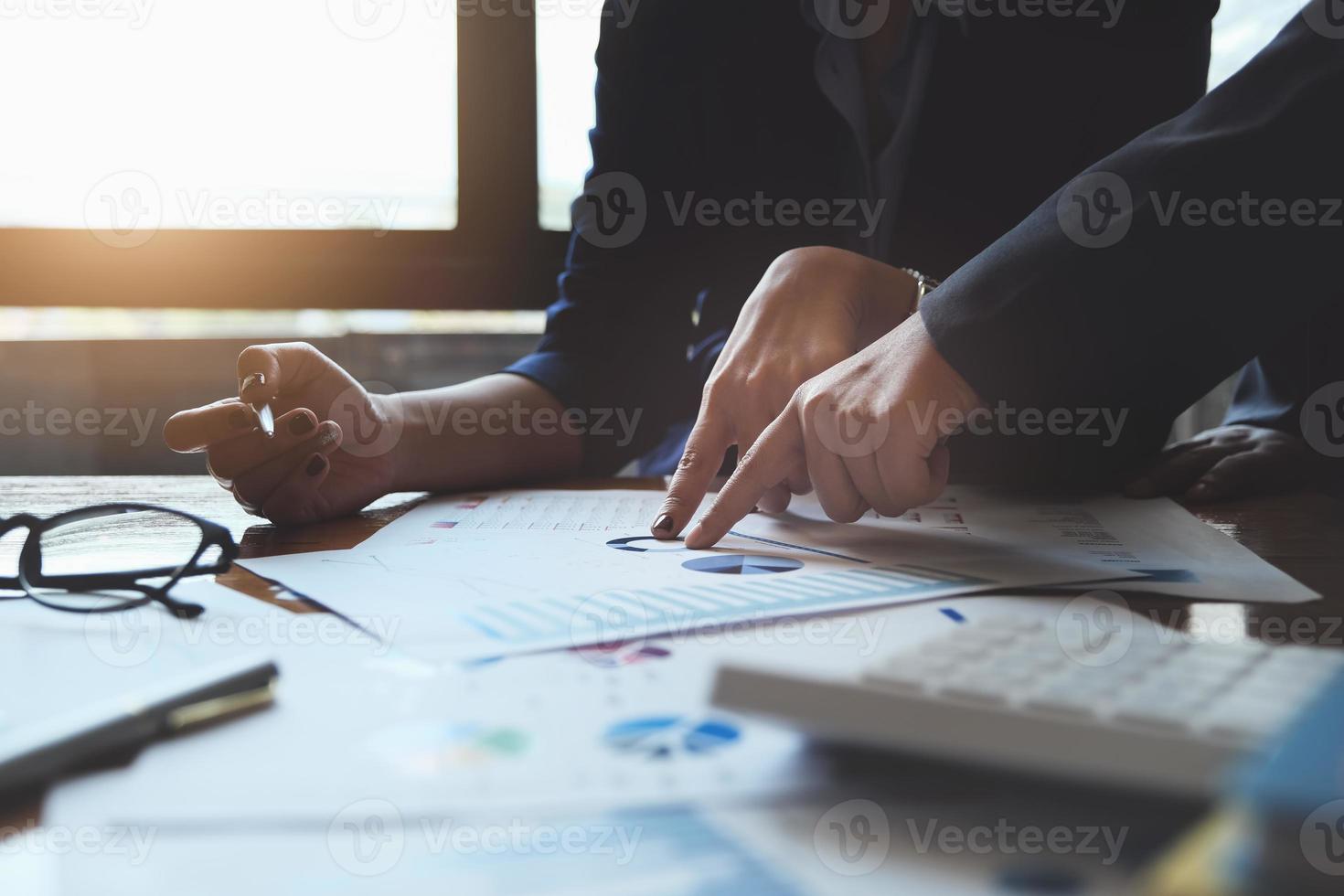 An auditor  pointing to documents to examine budgets and financial fraud. photo