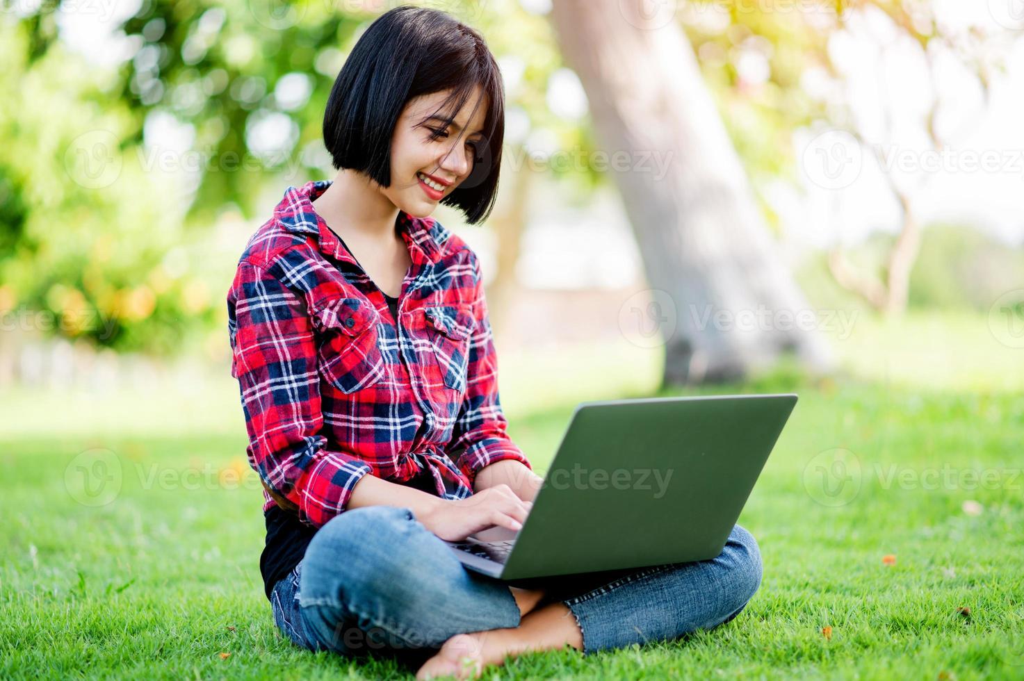 Asian women smile happily and laptop. Work online online communication Messaging Online learning Online communication concept photo